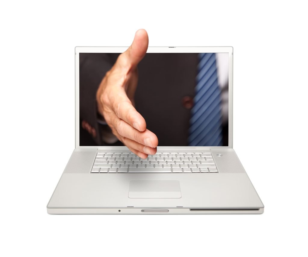 vecteezy-man-reaching-for-a-handshake-through-laptop-screen-16298474